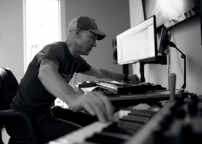man at keyboard editing music