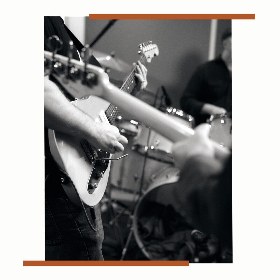 2 men playing guitar