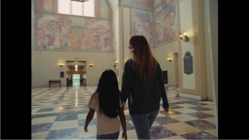 kid and woman walking in museum