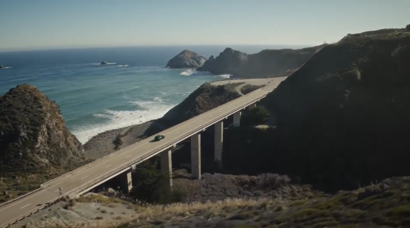 car going over bridge over ocean