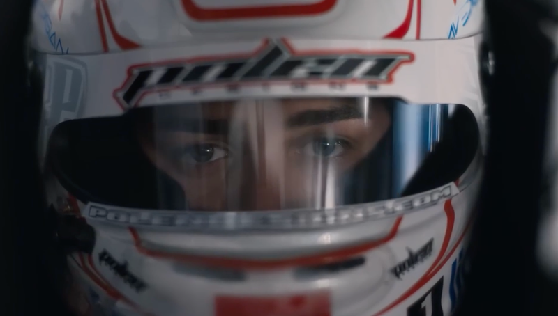 Girl race car driver with helmet on